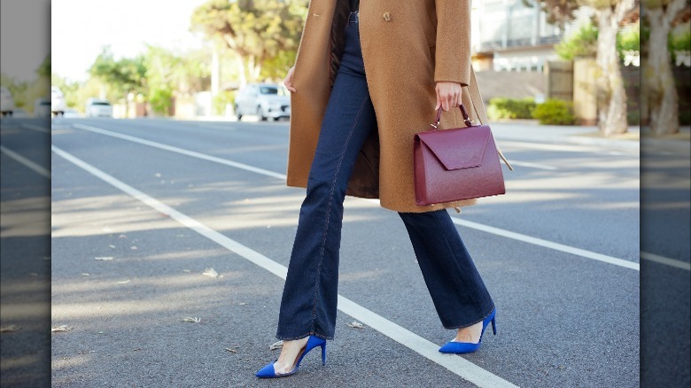 Model wearing flared jeans, heels