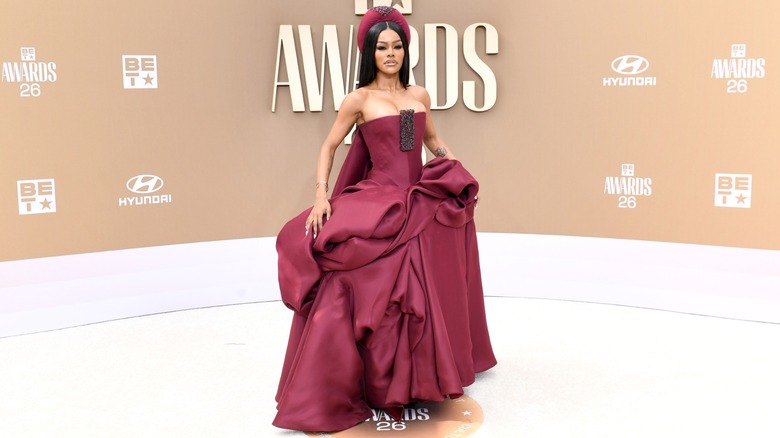 Teyana Taylor posing in a crimson dress on the red carpet of the 2026 BET Awards