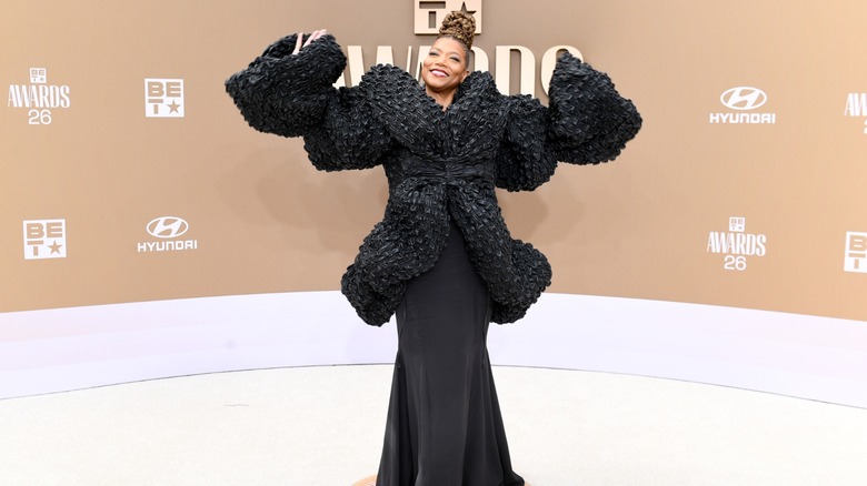 Queen Latifah with her arms outstretched on the red carpet at the 2026 BET Awards