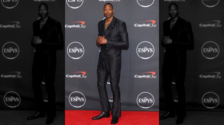 Dwight Howard in a double-breasted suit, posing with his hands together on the 2026 EPSYs red carpet