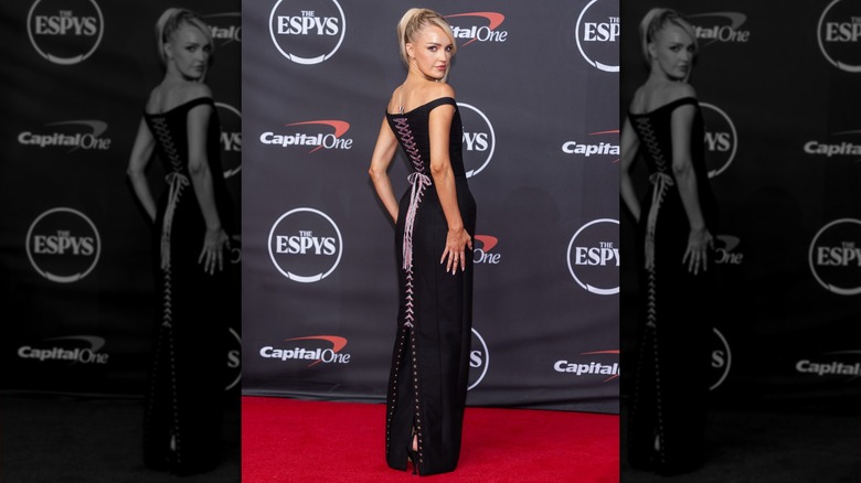 Morgan Riddle with her back to the camera in a lace-up dress on the ESPYs red carpet