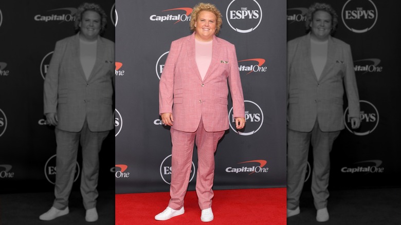 Fortune Feimster in a baby pink suit on the 2026 EPSYs red carpet, smiling