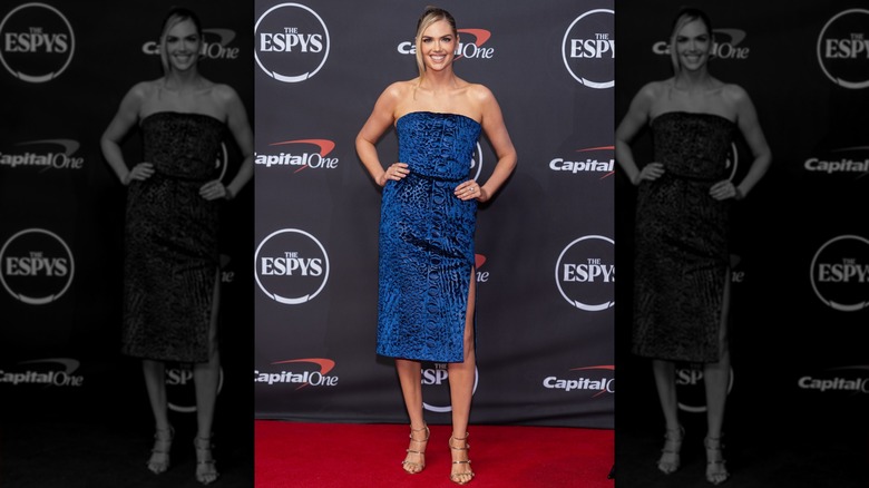 Kate Upton with her hands on her waist in a blue dress on the ESPYS red carpet in 2026, smiling
