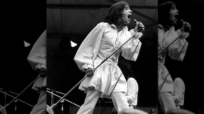 Mick Jagger performing in a shirtdress and choker in 1969.