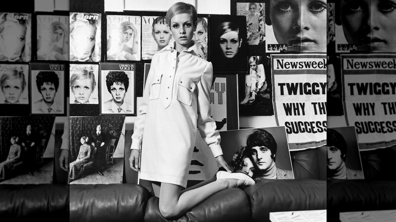 Twiggy kneeling on a sofa in a shirtdress in 1967.
