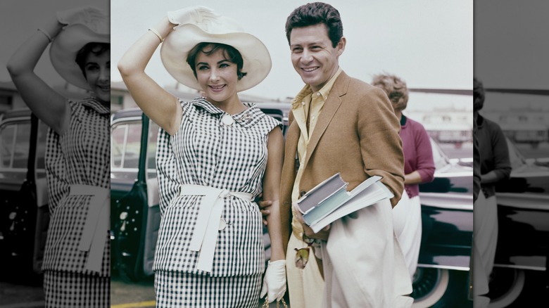 Elizabeth Taylor in a checked dress, alongside Eddie Fisher, circa 1960.