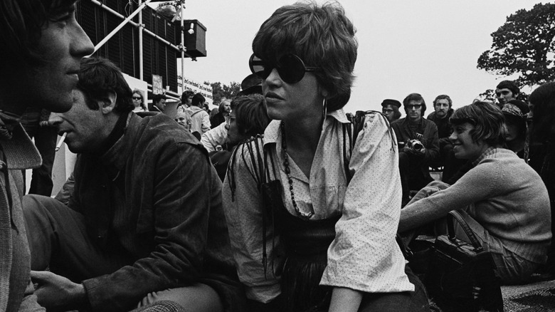 Jane Fonda sitting on the grass at the Isle of Wight Festival in 1969.