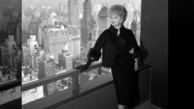 Lucille Ball looking out at New York from a balcony.