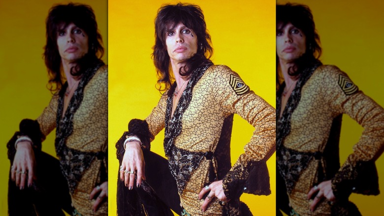 Stephen Tyler wearing a bright yellow shirt with black cuffs in 1986.
