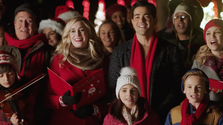 Jesse Metcalfe and Fiona Gubelmann in a crowd in Christmas Next Door