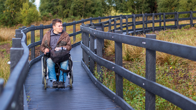 Man in a wheelchair on accessible path