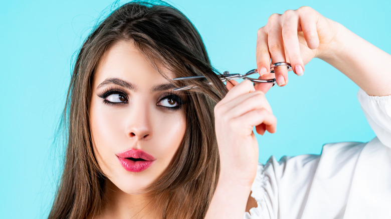 woman cutting her own bangs