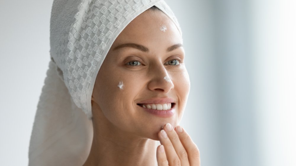 a woman applying a cream, a beauty tip when you're stuck at home