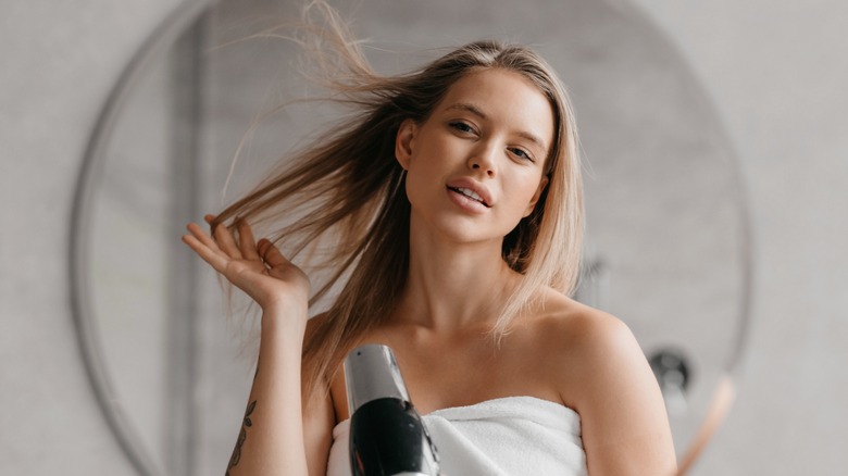 Woman blow drying hair