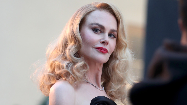 Nicole Kidman looking down and off to the side with a smirk at Vogue World 2025