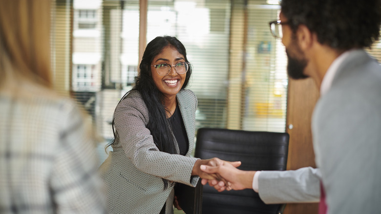 professional woman shaking man's hand