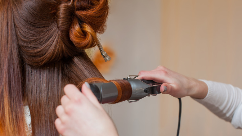 Woman using curling iron