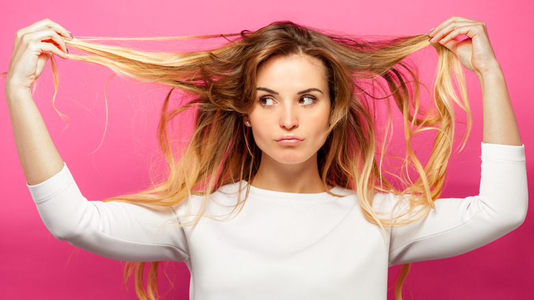 woman holding her blond hair