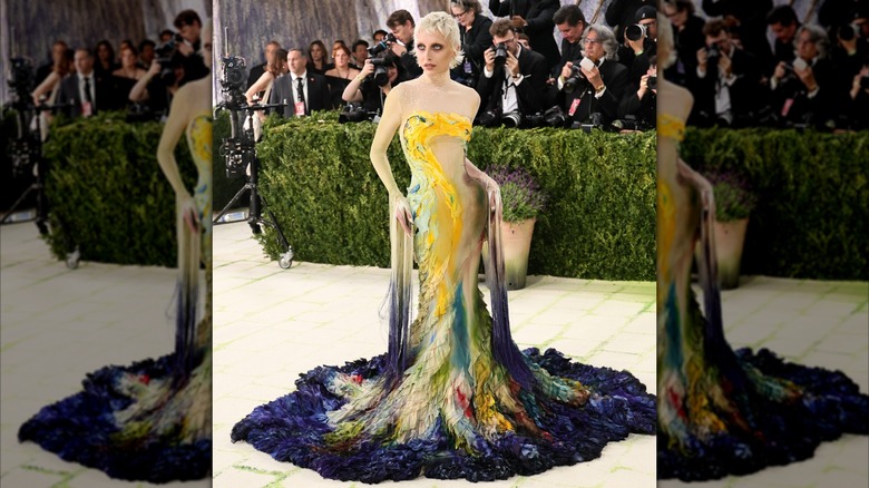 Sabrina Carpenter in a long, colorful, oil-painting looking dress with long hanging sleeves at the 2026 MET Gala