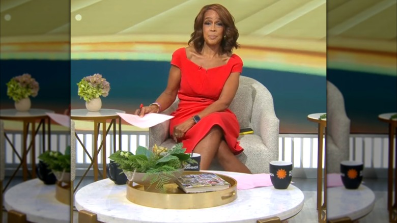 Gayle King smiles in a red dress