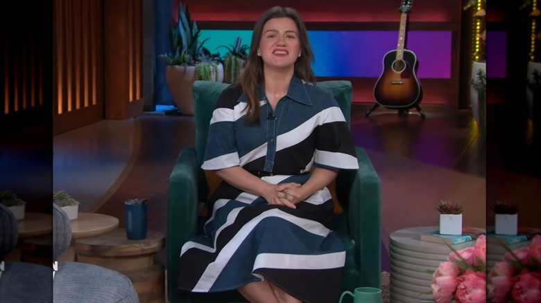 Kelly Clarkson in a blue, white, and black striped dress