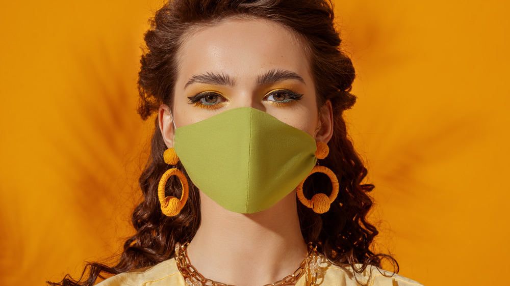 Woman wearing orange hoop earrings