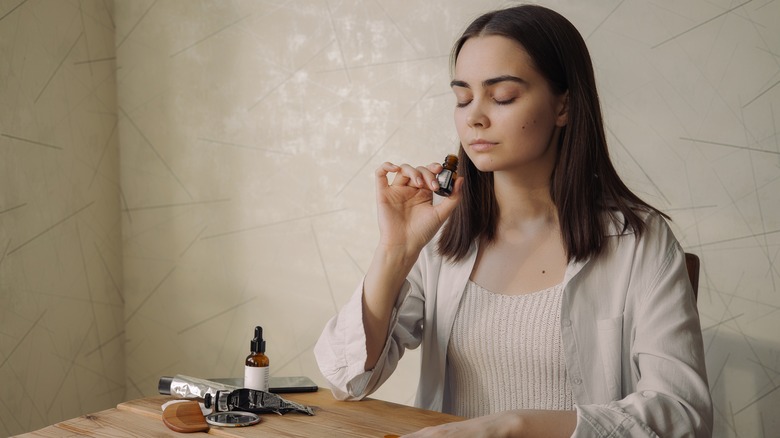 Woman inhaling essential oil