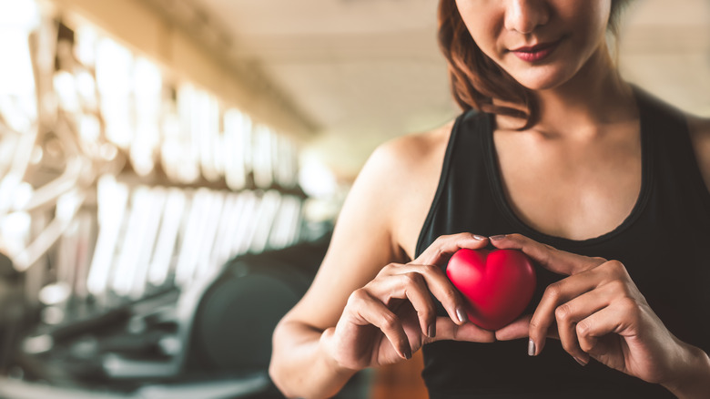 Person holding red heart in gym