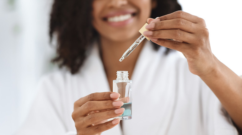 Woman holding facial serum 