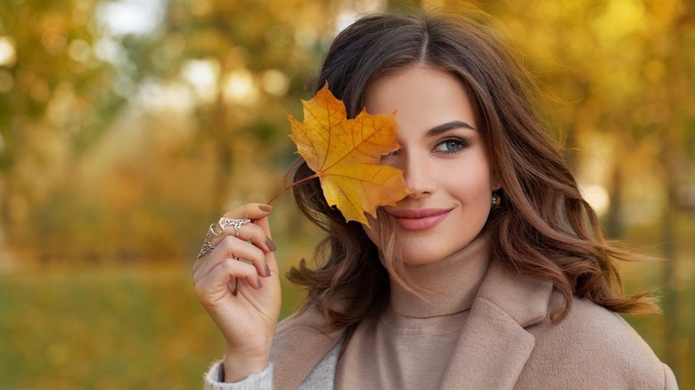 Woman holding leaf