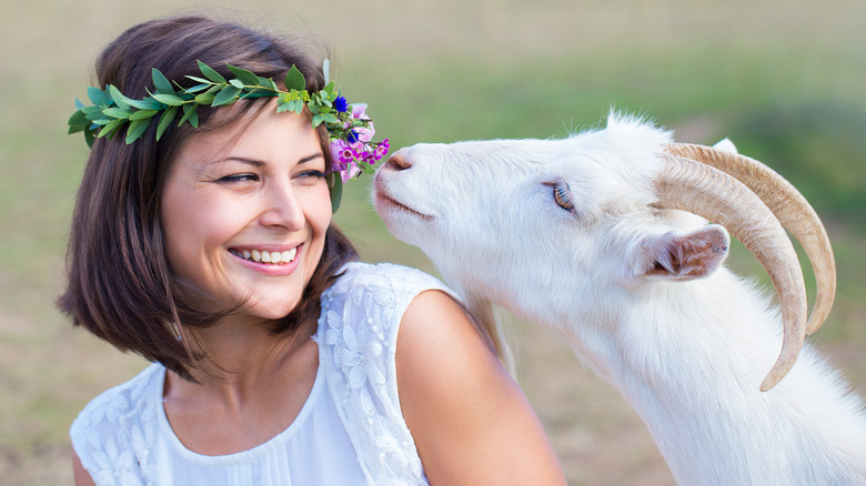 Smiling woman with goat