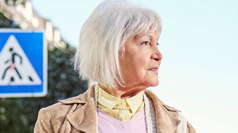 Older woman crossing the street