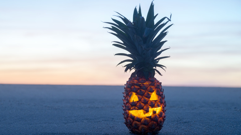 A jack-o-lantern pineapple on the beach