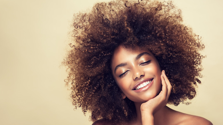 Woman with natural hair smiling