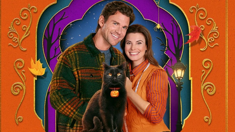 Kevin McGarry, Meghan Ory, and a black cat in promotional artwork for 'The Spirit of Halloween'