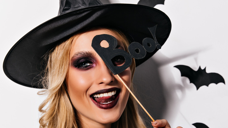 A girl dressed as a witch with a dramatic eyeshadow look