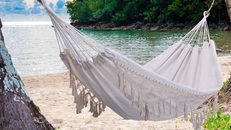 White boho tassle hammock hanging at the beach