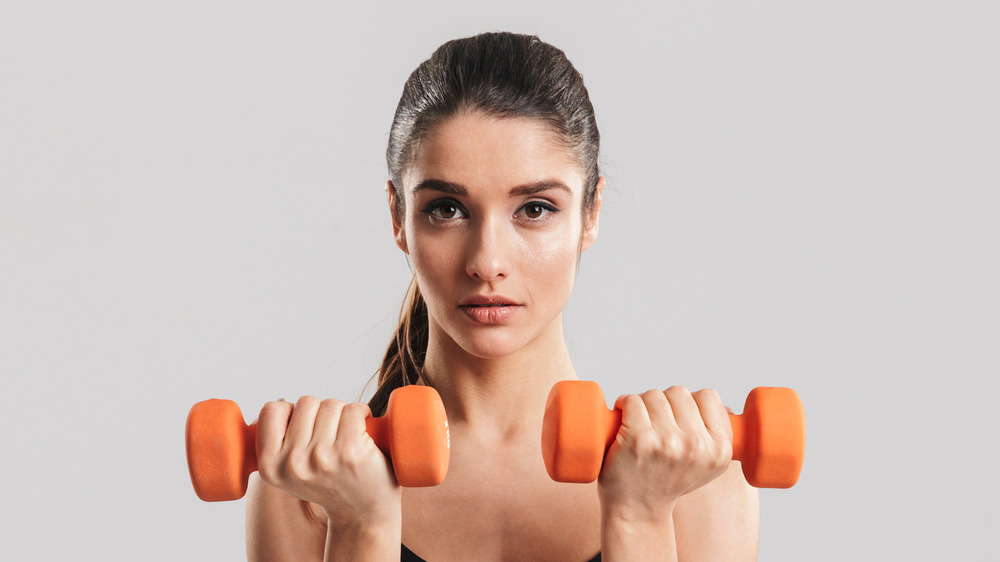 woman holding dumbbells