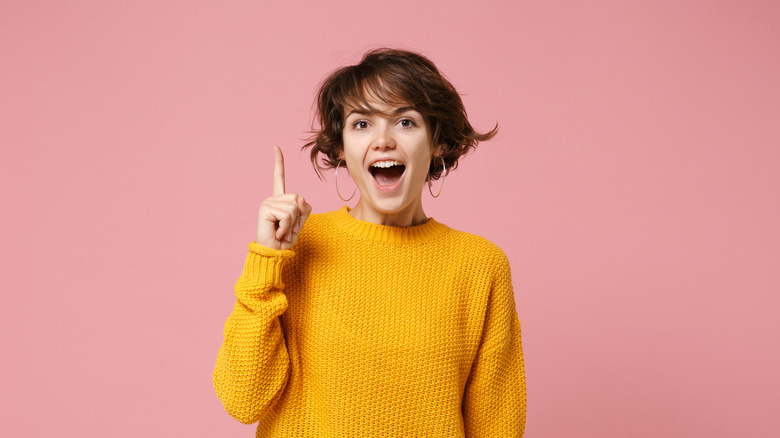 Excited young woman having a thought