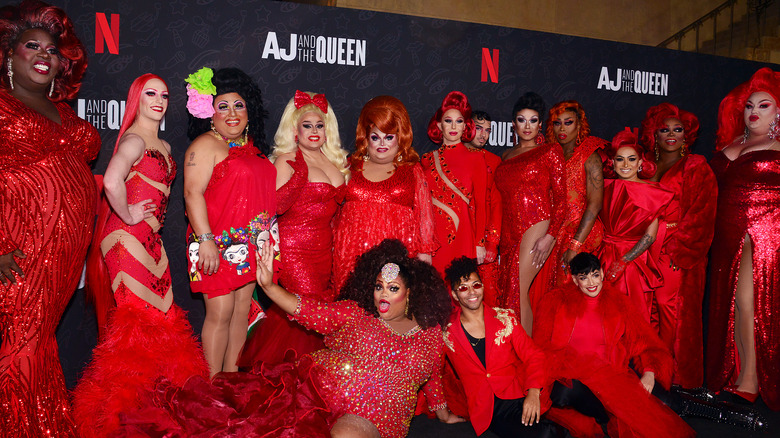 Drag queens in red on red carpet