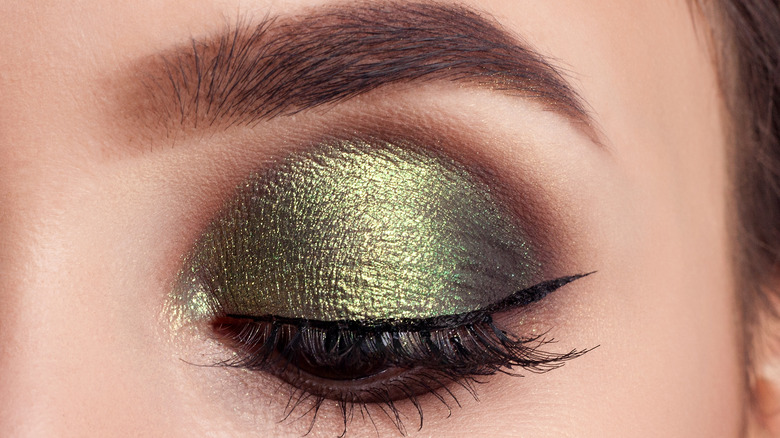 Close-up of woman with olive green eyeshadow look