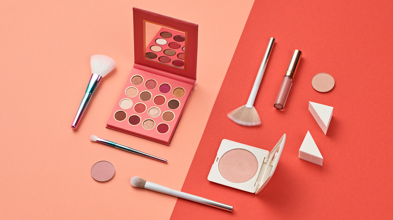 Makeup and makeup brushes sitting on a table