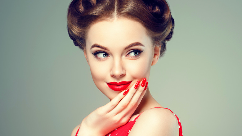 girl smiling in red polka dot dress 