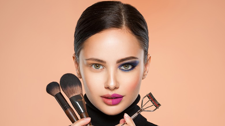 Woman holding makeup tools