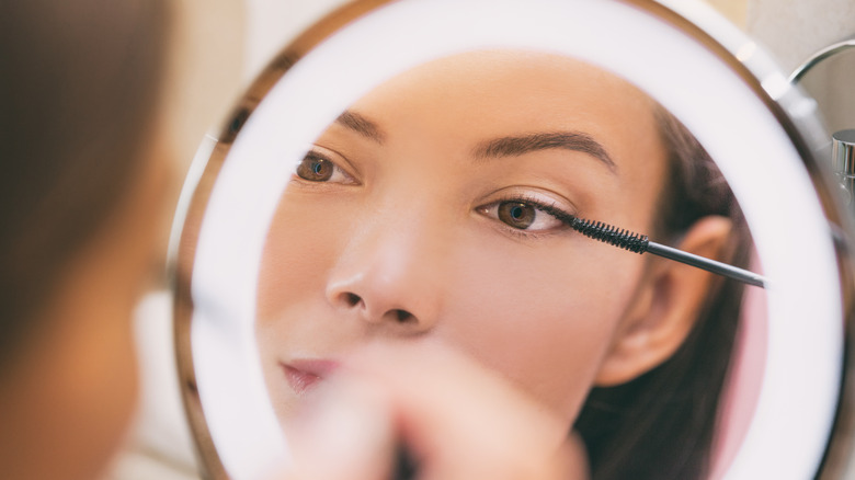 Woman applying mascara 