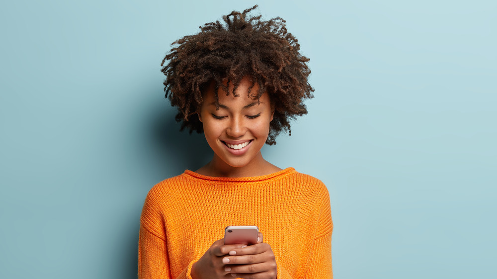 A woman looking at dating app on phone