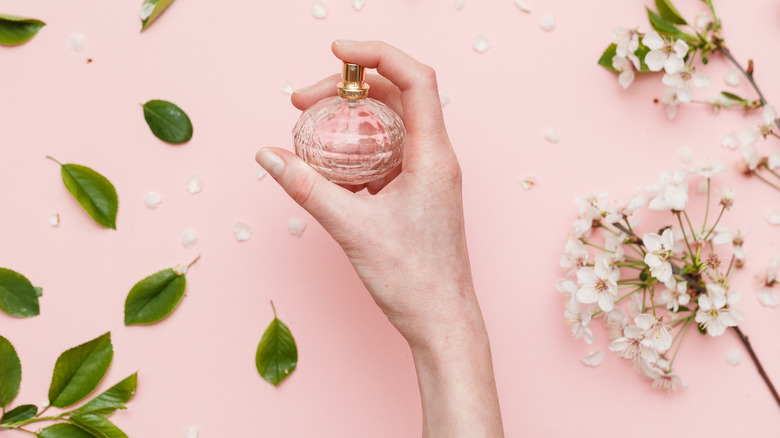 Hand holding cherry blossom perfume