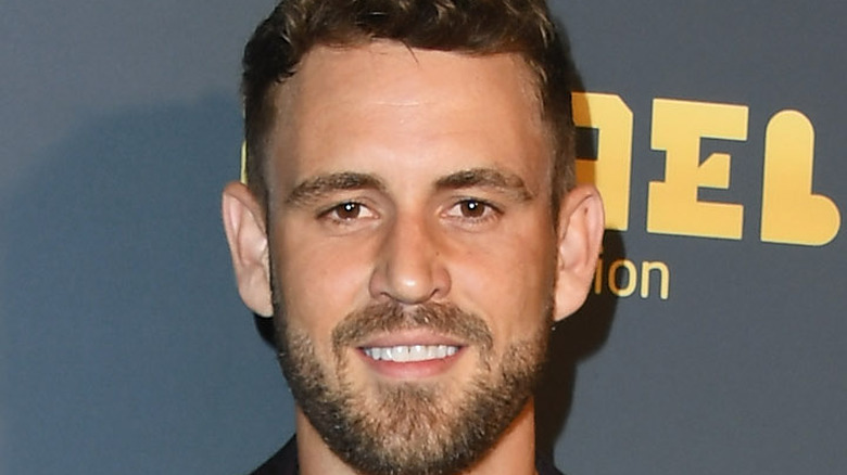Nick Viall smiles at an event