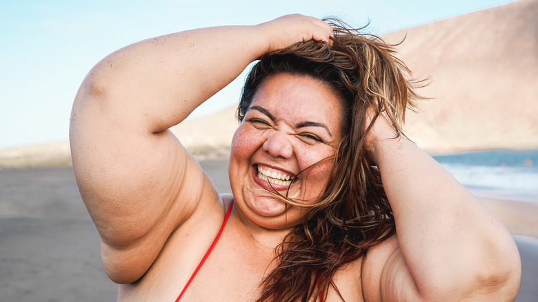 woman laughing in swimsuit