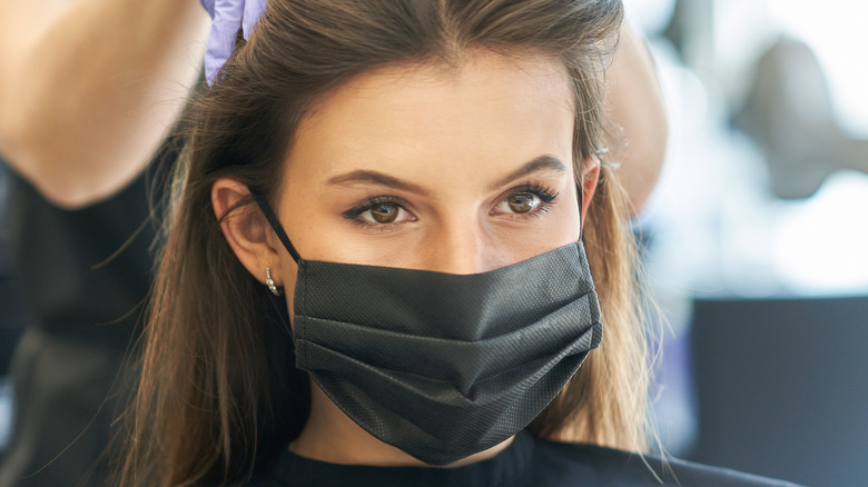 Masked woman at the salon